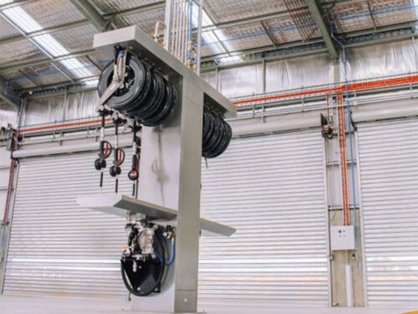 Repair shop hangs hose reels for cleaning.