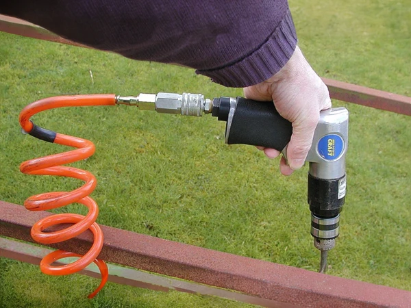 The air nail gun equipped with a reinforced PU air hose is being installed
