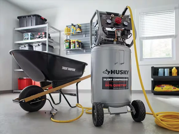 A spray paint can with a reinforced PU air hose is placed in front of a small cart