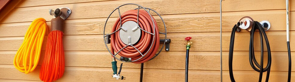 Wall mount hose reel on the wall with orange hose